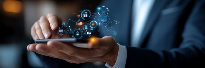 Hands of a corporate team interacting with a futuristic digital device; floating tech icons symbolize system integration and post-acquisition, tech-driven strategy.